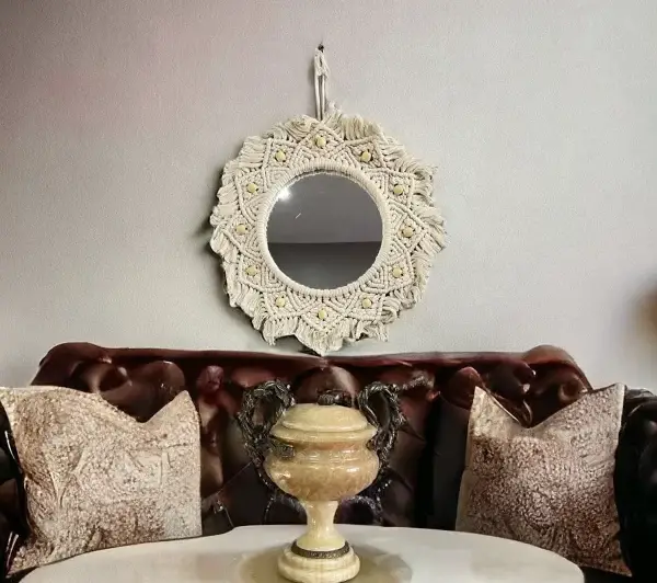 Handmade round Macrame mirror hanging on a wall