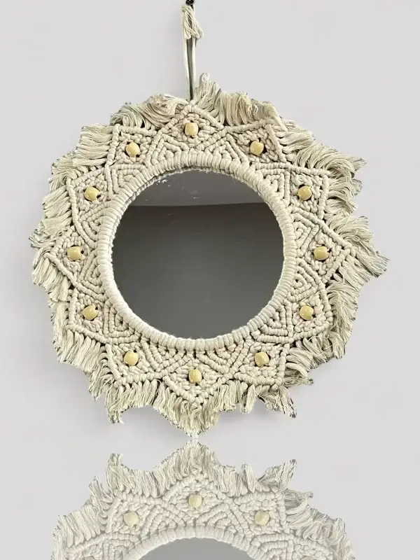 Handmade round Macrame mirror hanging on a wall