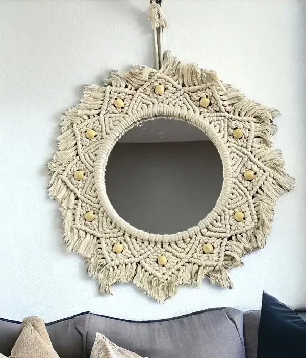 Handmade round Macrame mirror hanging on a wall