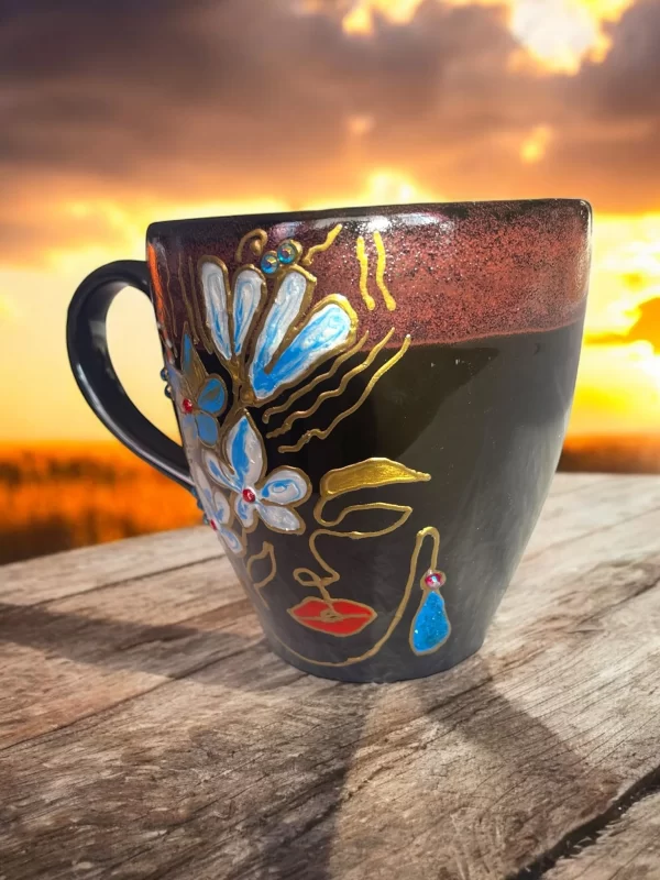 Handcrafted Black Ceramic Face Mug with Blue Floral and Gold Accents - Image 3